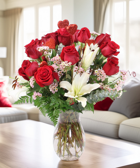 Ignite the passion and watch the sparks fly with this fragrant design of six red roses, fragrant white Oriental lilies and accents in a glass vase.