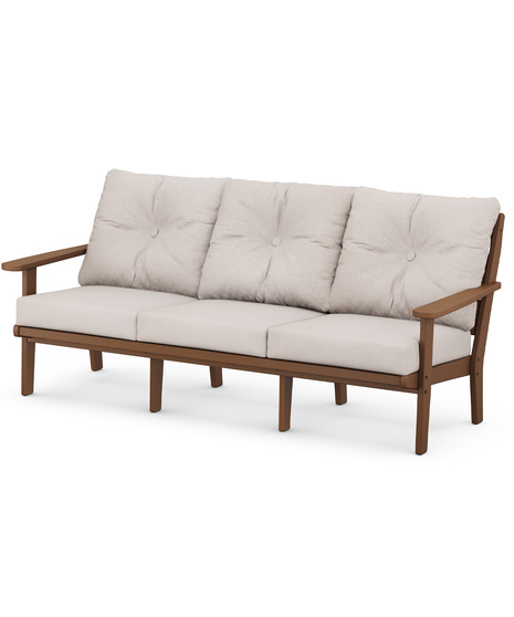 The Lakeside Deep Seating Sofa seats up to three and achieves laid-back comfort and style with plush pillow-back cushions and timeless back design.