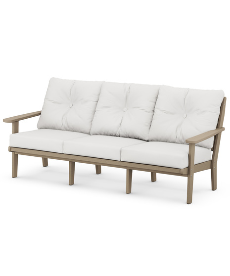The Lakeside Deep Seating Sofa seats up to three and achieves laid-back comfort and style with plush pillow-back cushions and timeless back design.