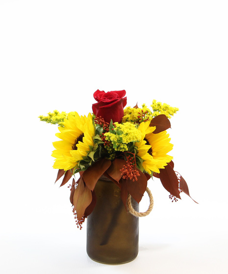 This bright  bouquet is displayed in a colored vase with a rope detail and features three sunflowers,  accented by eucalyptus and solidago.