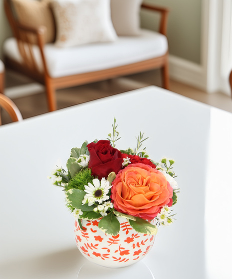 A garden rose, moss carnation, and carnation in a ceramic floral pot. A charming little bouquet perfect for gifting or brightening any space.