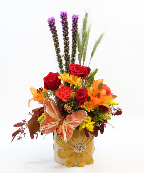  This abundant arrangement features a delightful array of Asiatic lilies, graceful liatris, fun fall daisies, charming carnations, and more in a ceramic flower container.