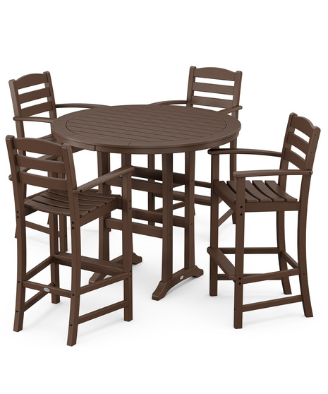 This bar-height table seats four and features a table top with rounded edges and space for plenty of leg room underneath paired with traditional La Casa Café Bar Arm Chairs