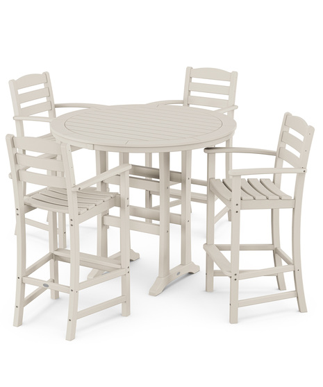 This bar-height table seats four and features a table top with rounded edges and space for plenty of leg room underneath paired with traditional La Casa Café Bar Arm Chairs