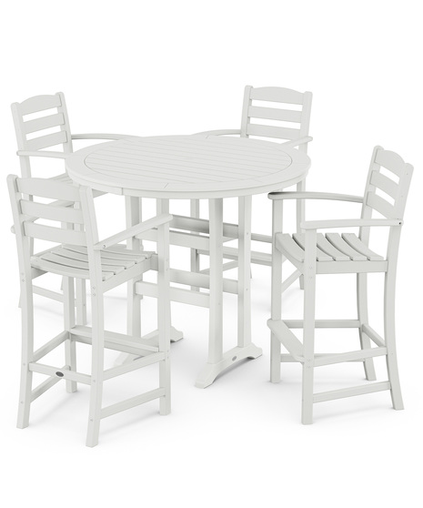 This bar-height table seats four and features a table top with rounded edges and space for plenty of leg room underneath paired with traditional La Casa Café Bar Arm Chairs