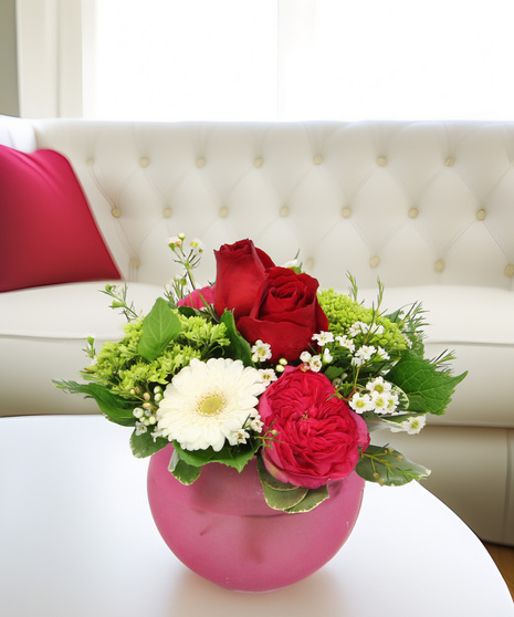 A cheerful mix of flowers in a sleek sphere vase. Simple Pleasures is a warm and inviting bouquet perfect for gifting or treating yourself.