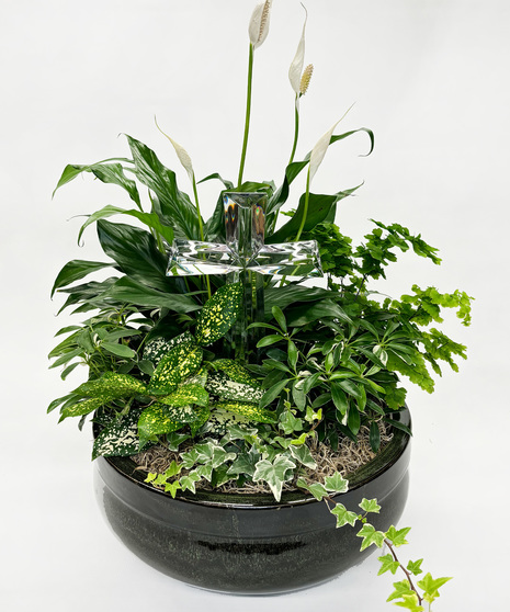 This handcrafted garden promotes hope.  Featuring a peace lily alongside a mix of green and white plants in a burnished silver metal container with a crystal cross figurine.