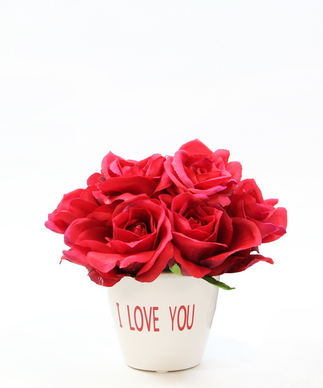 Silk roses in a white ceramic pot with I Love You in red letters.