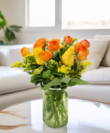 ranunculus blossoms with their delicate petals in a textured gold  vase creating a charming arrangement that's perfect for gracing any space with a touch of soft beauty.