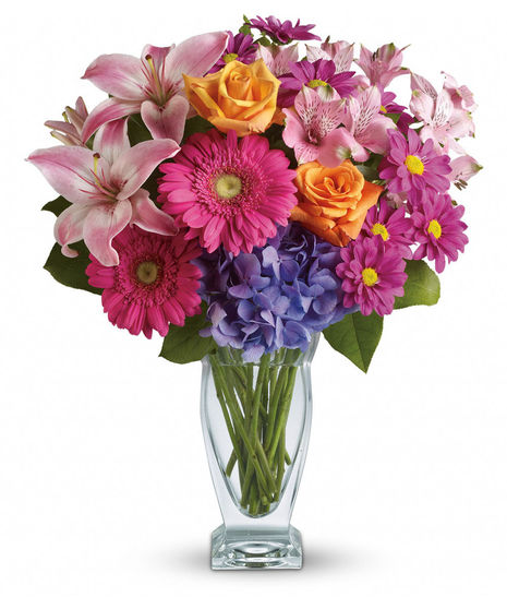 This versatile mix includes blue hydrangea, orange roses, light pink Asiatic lilies, pink alstroemeria, hot pink gerberas and purple daisies with a bit of rich green salal.