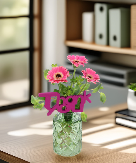 Three micro gerbera daisies in a colored vase with a Thank You pick. A sweet and sincere way to show appreciation for someone special.