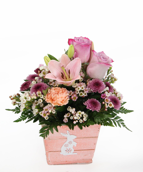 A bright bunny box is filled with blossoms of Asiatic lilies, carnations, and accents.  Fun and festive! 