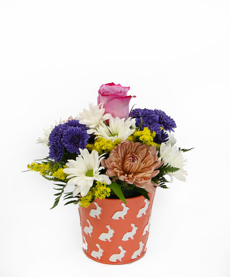 AAdd a charming touch for the holiday with this bright tin embossed with bunnies is filled with daisies, button poms and disbuds.  
