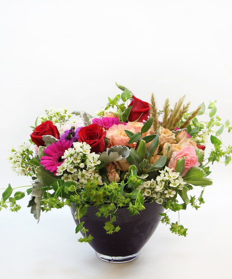 Low and lush, a luxury bouquet in a low glass bowl.