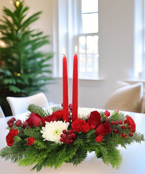 Red and white holiday centerpiece with taper candles, evergreens, carnations & spider mums. Festive arrangement with icy berry accents