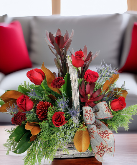 Nature’s Splendor is a luxury rustic winter basket with evergreens, magnolia, leucadendron, eryngium & pinecones. Elegant, textural, and timeless