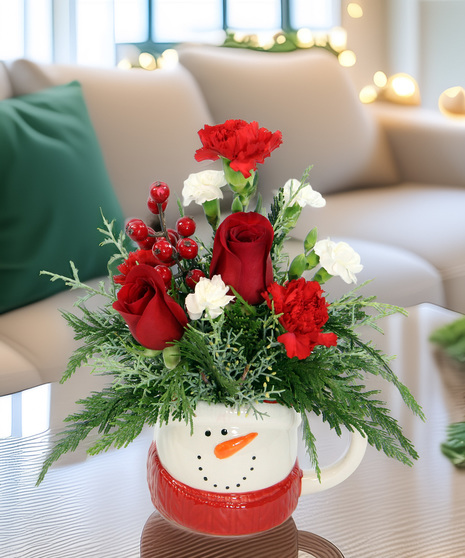 Festive snowman mug filled with red & white flowers and berries. A cheerful two-in-one holiday gift - a bouquet and keepsake mug!