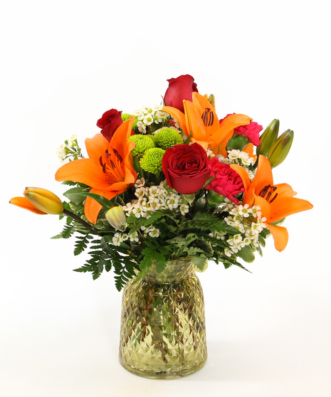 Sunshine bouquet with Asiatic lilies, carnations & poms in a glass vase. Bright, cheerful floral gift perfect for gifting