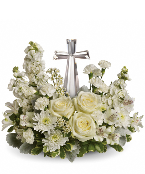 this beautiful arrangement will comfort the bereaved in a truly thoughtful and respectful way. An exquisite crystal cross is surrounded by a bed of lovely blossoms.