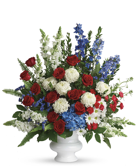 A classic display of patriotic red, white and blue flowers pays tribute to the memory of one who proudly served his country, and is a testament to hope, freedom and strength.