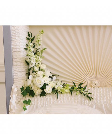 This serenely beautiful arrangement of white orchids, white roses and other popular white flowers is a fitting and very personal tribute when placed inside the casket.