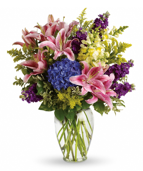 Celebrate the beauty of a life fully lived with this lovely array of pink lilies, blue hydrangea and other floral favorites in a vase