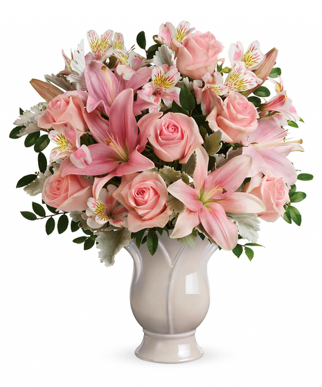 Share your heartfelt feelings on the loss of someone special with this feminine arrangement of soft pink roses and lilies.