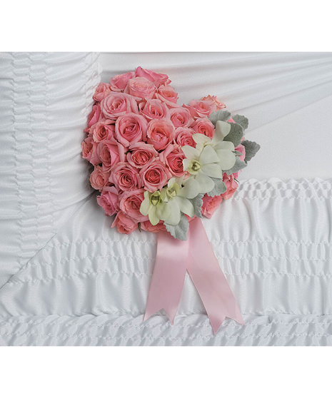 A heartfelt tribute to your love, this sweet pink rose heart is adorned with delicate white orchids for an uplifting casket arrangement.