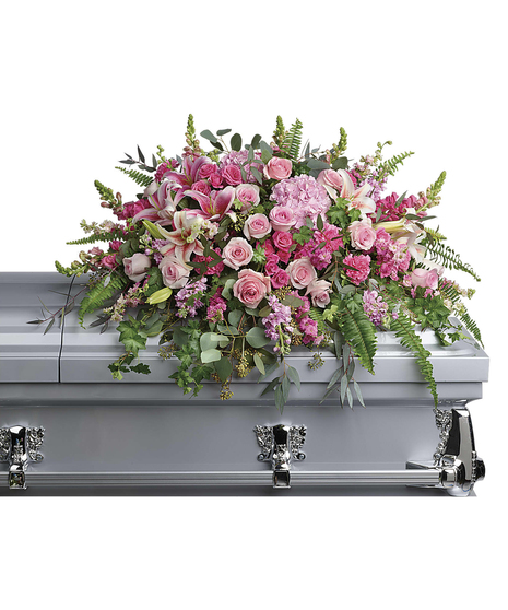 An exuberant celebration of a beautiful life, this glorious bouquet of pink hydrangea, roses and lilies adds feminine grace to the service.
