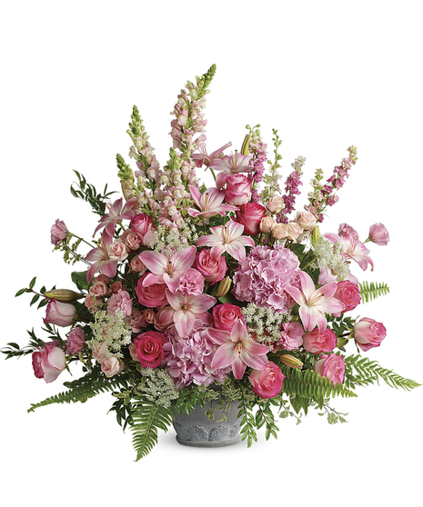 An exuberant celebration of a beautiful life, this glorious bouquet of pink hydrangea, roses and lilies adds feminine grace to the service.
