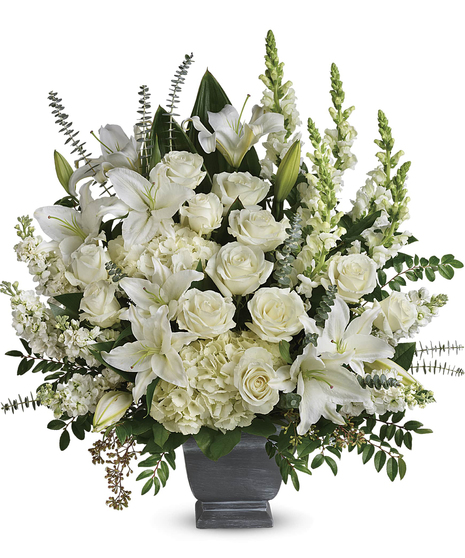 Like the sun on the horizon, this pure white bouquet of hydrangea, roses and lilies offers hope and inspiration after the loss of a loved one.