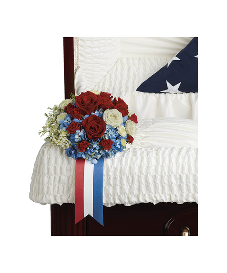 Celebrate the honorable legacy of your loved one with this patriotic display of blue hydrangea and white and red roses.