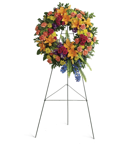 A rainbow of love. Celebrate your colorful memories of a beautiful life with this radiant wreath of hydrangea, roses and lilies.