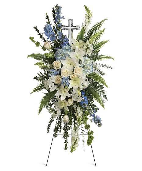 A touching display of devotion, this peaceful spray of white and light blue flowers is accompanied by an elegant crystal cross 