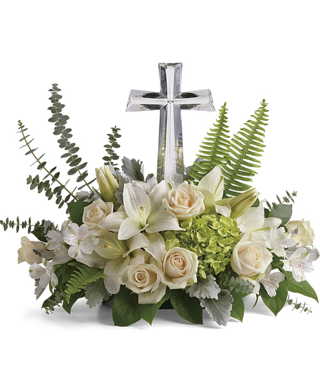 This peaceful bouquet of soft white flowers and green accents is a beautiful message of sympathy, adorned with a large crystal cross keepsake. 